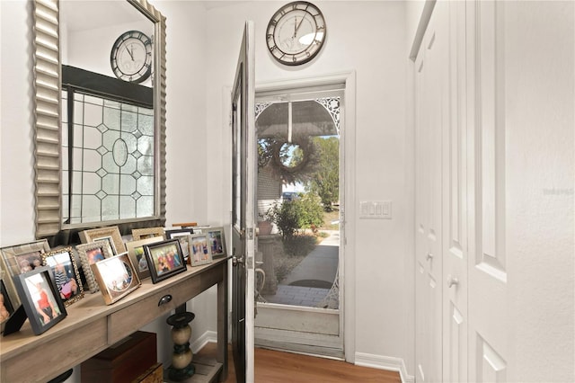 foyer with wood finished floors and baseboards