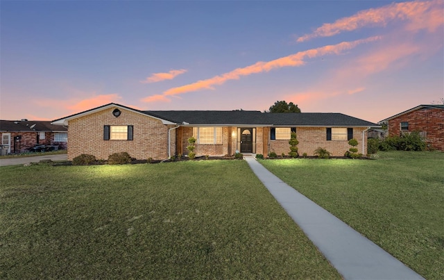 ranch-style house with a lawn