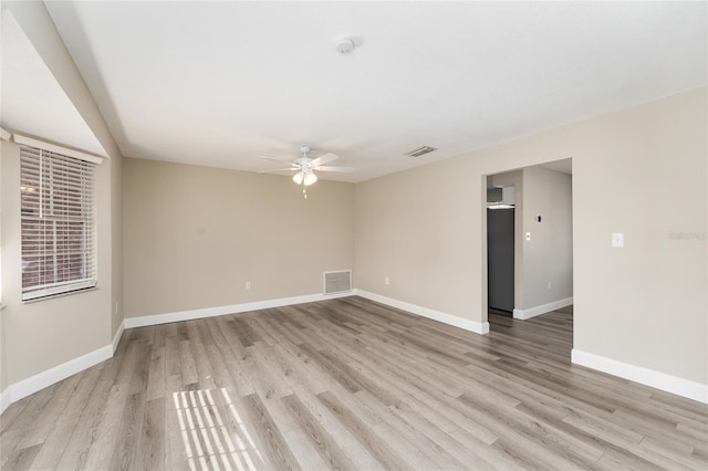 empty room featuring light hardwood / wood-style flooring and ceiling fan