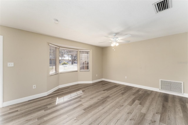 empty room featuring ceiling fan and light hardwood / wood-style flooring