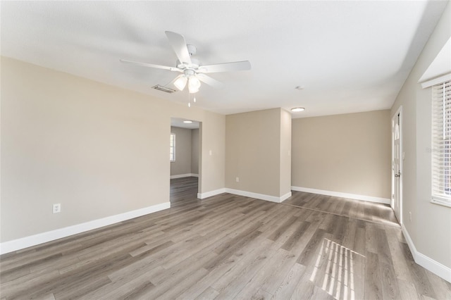 empty room featuring ceiling fan and hardwood / wood-style floors