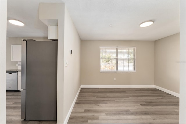 empty room with light hardwood / wood-style flooring