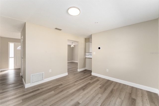 empty room featuring ceiling fan and light hardwood / wood-style flooring