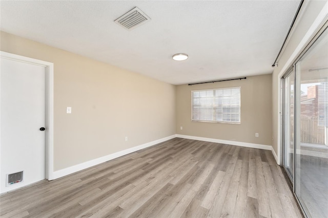 unfurnished room featuring light wood-type flooring