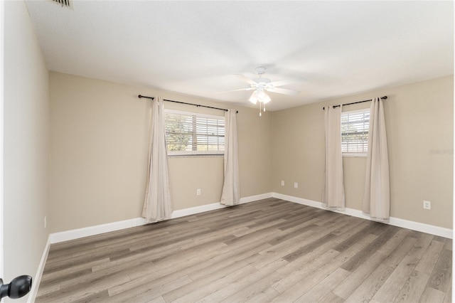 spare room featuring light wood-type flooring and ceiling fan