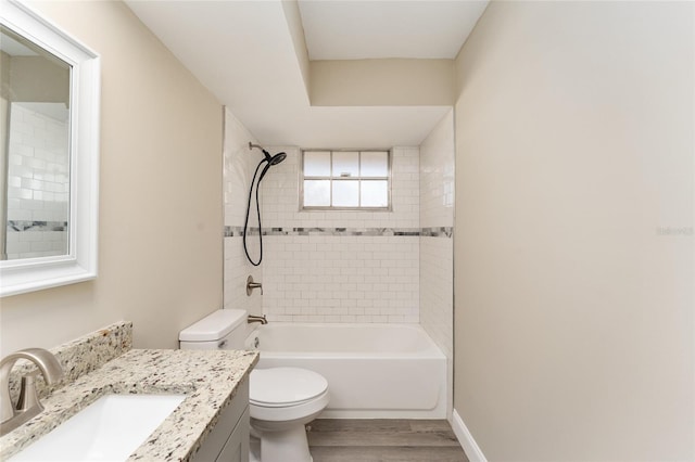 full bathroom with vanity, toilet, wood-type flooring, and tiled shower / bath