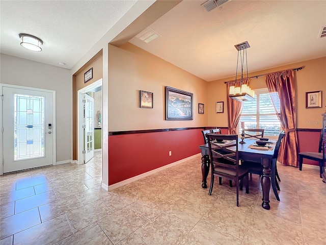 dining area featuring a textured ceiling