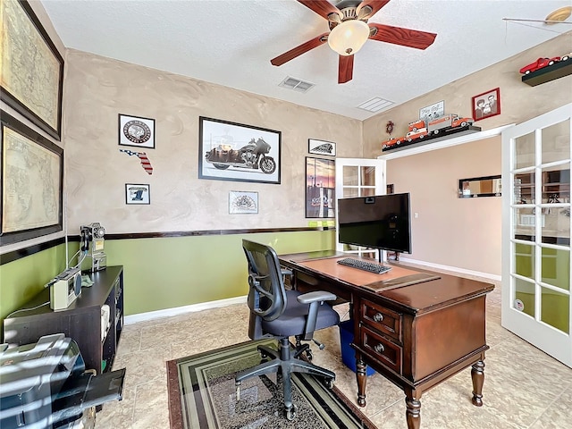 office area featuring ceiling fan and a textured ceiling