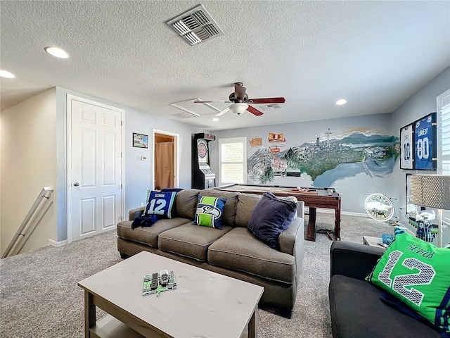 carpeted living room with a textured ceiling and ceiling fan