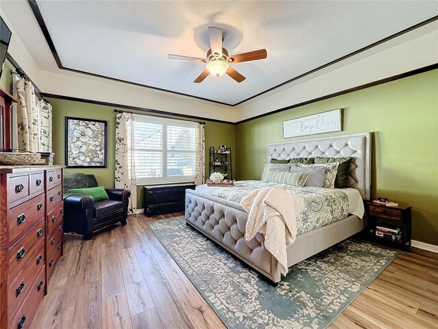 bedroom with a textured ceiling, light hardwood / wood-style flooring, and ceiling fan