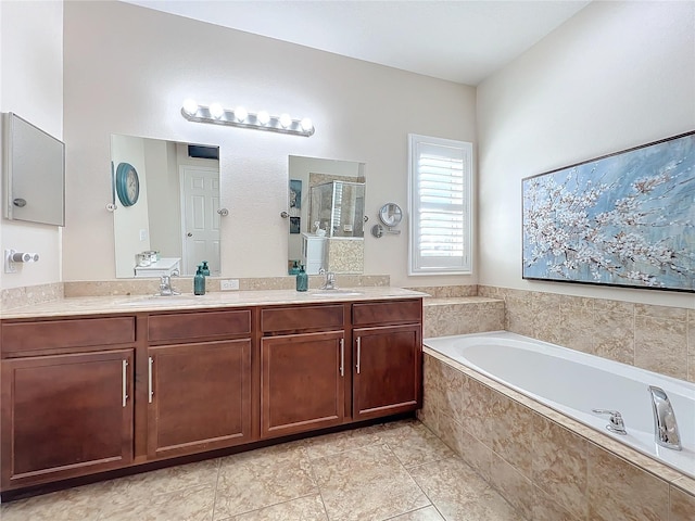 bathroom with vanity and independent shower and bath