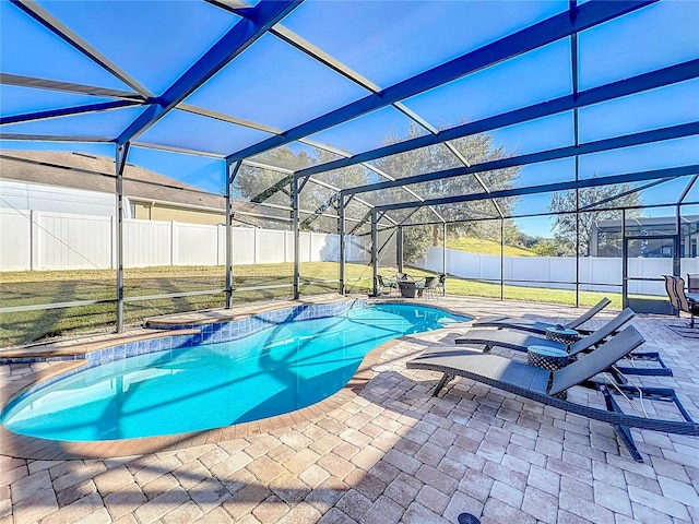 view of swimming pool with a yard, glass enclosure, and a patio area