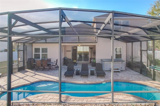 view of swimming pool featuring a lanai, a patio, and a hot tub