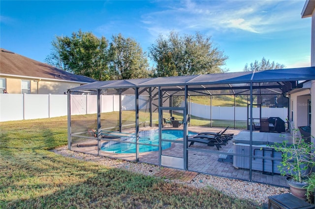 exterior space with a patio, a fenced in pool, and glass enclosure