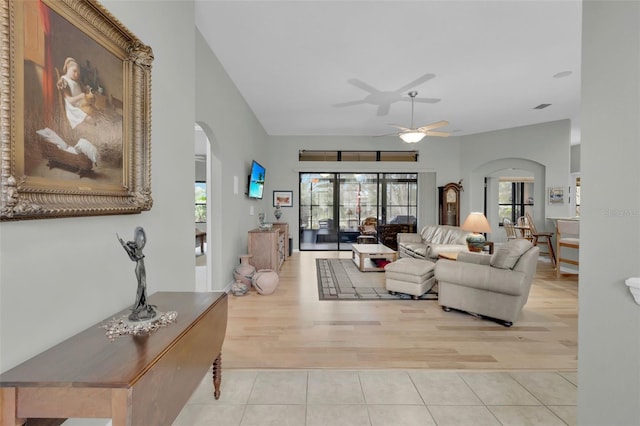 living room with light wood-type flooring and ceiling fan