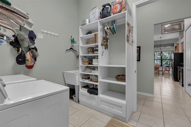 washroom with separate washer and dryer and light tile patterned flooring