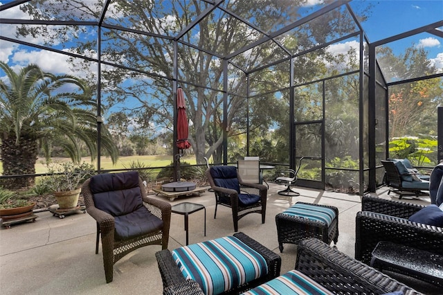 view of patio featuring glass enclosure