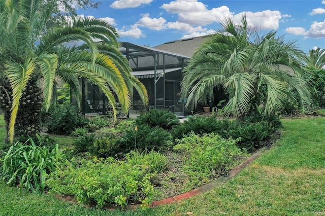 view of yard with glass enclosure