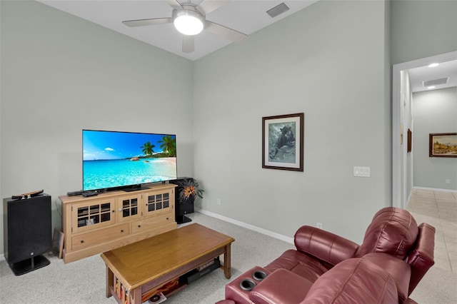 living room with a ceiling fan, baseboards, and visible vents