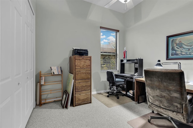carpeted home office featuring baseboards and ceiling fan