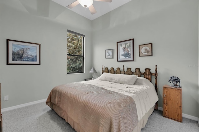 bedroom with light carpet, ceiling fan, and baseboards