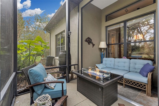 sunroom / solarium with a wealth of natural light and an outdoor living space with a fire pit
