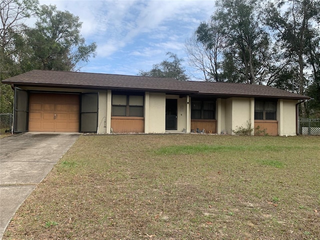 ranch-style home with a garage and a front lawn