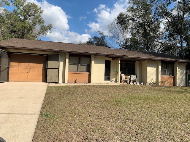 ranch-style house with a garage and a front lawn