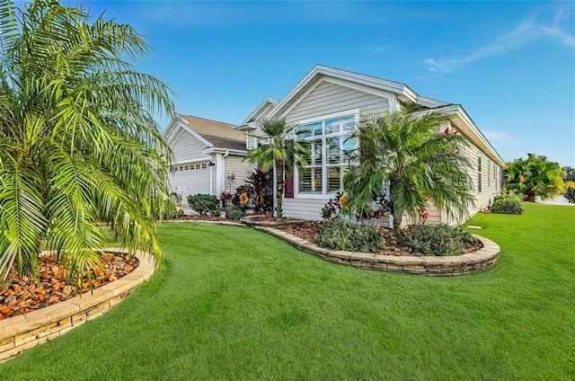 view of front of house with a garage and a front yard