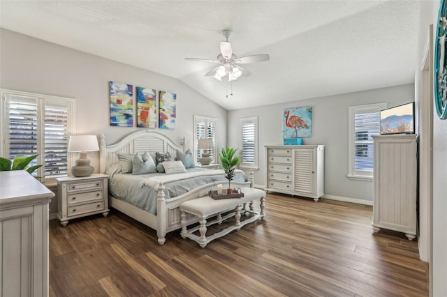 bedroom featuring dark wood-type flooring, ceiling fan, vaulted ceiling, and a textured ceiling