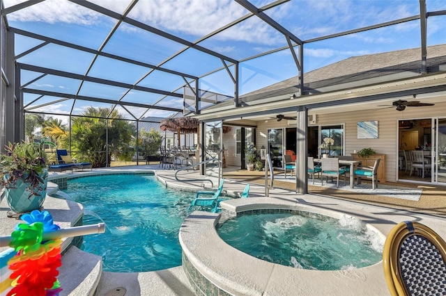 view of swimming pool featuring an in ground hot tub, pool water feature, a lanai, ceiling fan, and a patio area