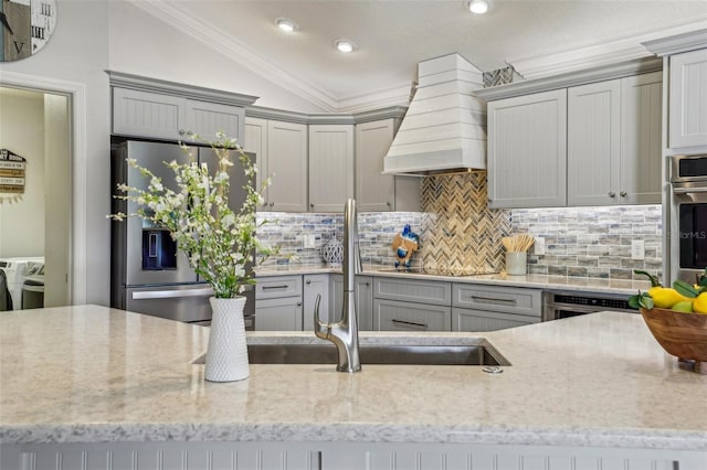 kitchen featuring custom exhaust hood, vaulted ceiling, appliances with stainless steel finishes, and gray cabinetry