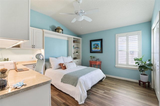 bedroom featuring ceiling fan, wood-type flooring, a textured ceiling, vaulted ceiling, and a closet