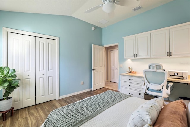 bedroom with lofted ceiling, hardwood / wood-style flooring, built in desk, and ceiling fan