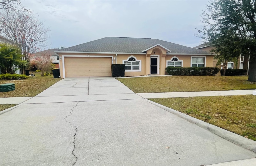 ranch-style home with a front lawn and a garage