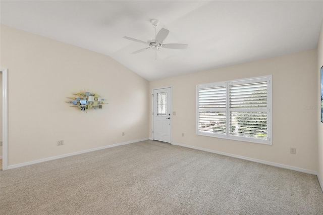 unfurnished room featuring ceiling fan, vaulted ceiling, and light carpet