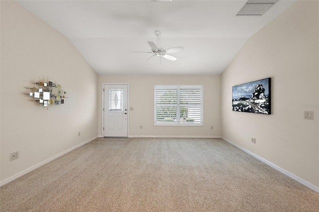 spare room with ceiling fan, light colored carpet, and lofted ceiling