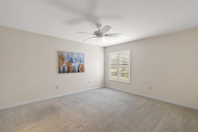 spare room with ceiling fan and light carpet