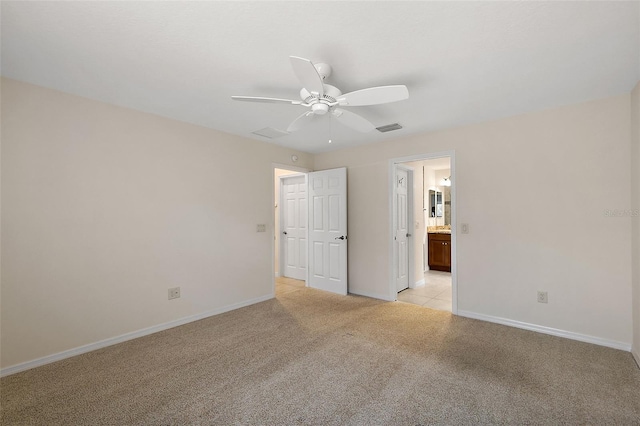 unfurnished room with ceiling fan and light colored carpet