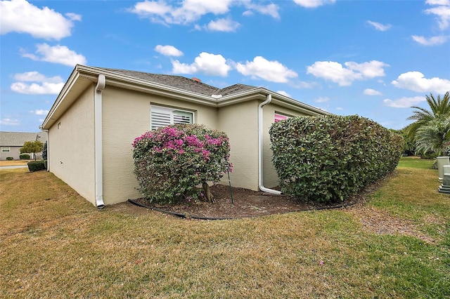 view of property exterior with a yard