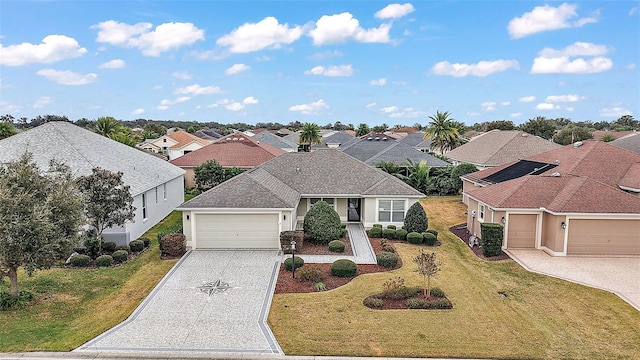 view of front of home with a garage and a front lawn