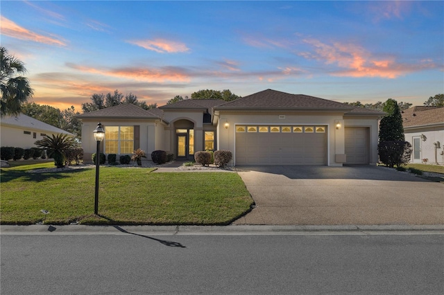 view of front facade featuring a garage and a yard