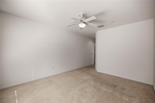 empty room featuring light carpet and ceiling fan