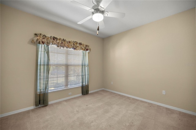 carpeted empty room featuring ceiling fan