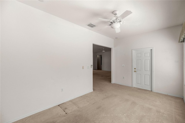 empty room with ceiling fan and light carpet