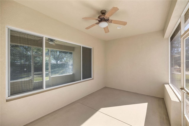 unfurnished sunroom with ceiling fan