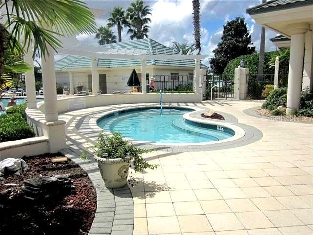 view of swimming pool with a pergola and a patio