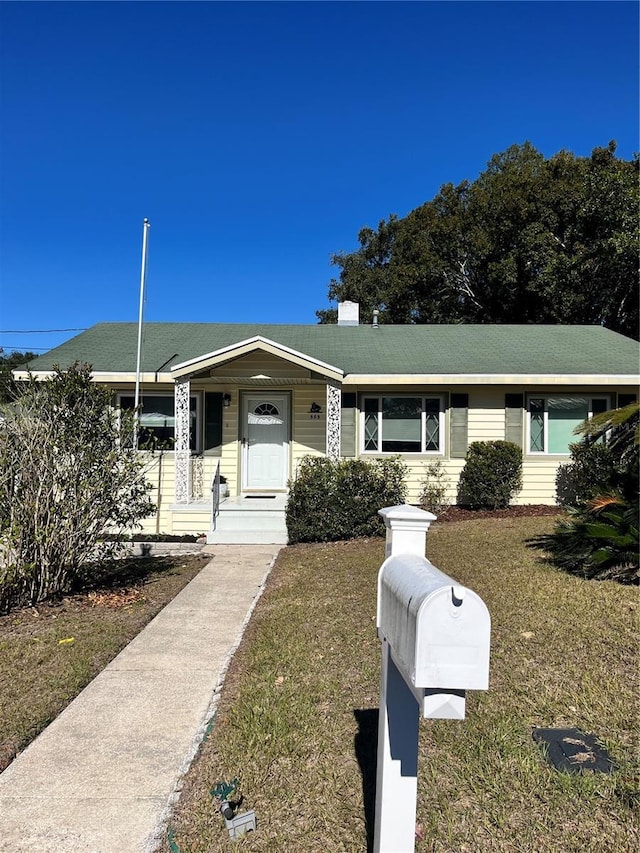 ranch-style house with a front lawn