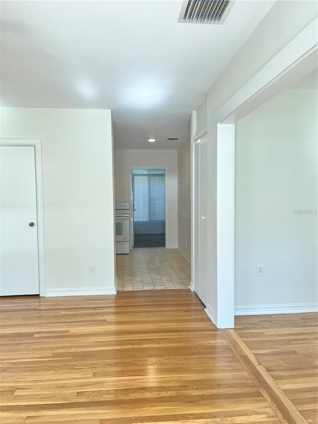 spare room with light hardwood / wood-style flooring