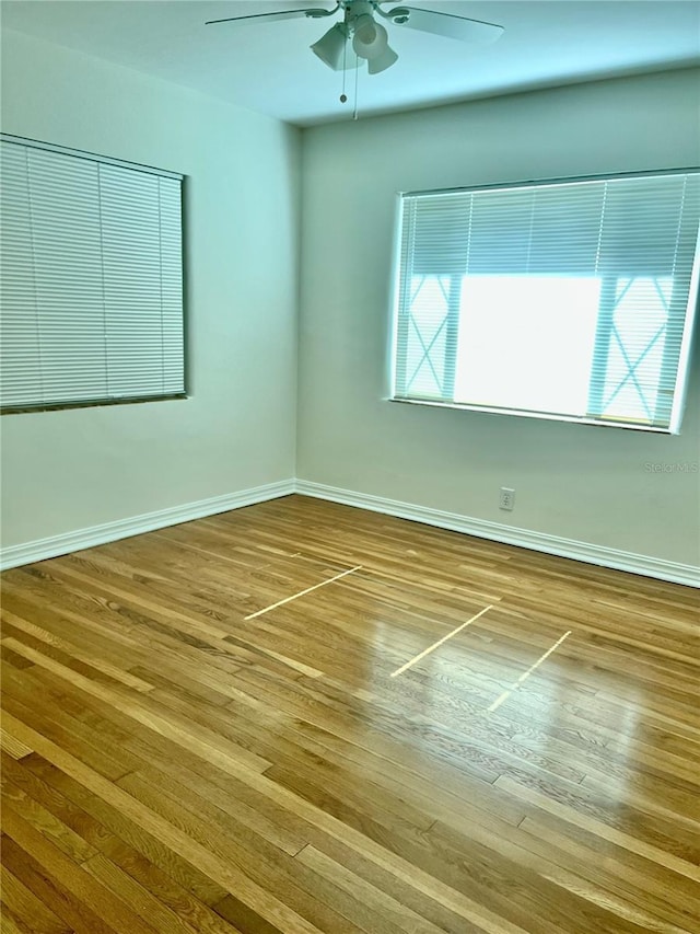 spare room featuring hardwood / wood-style floors and ceiling fan